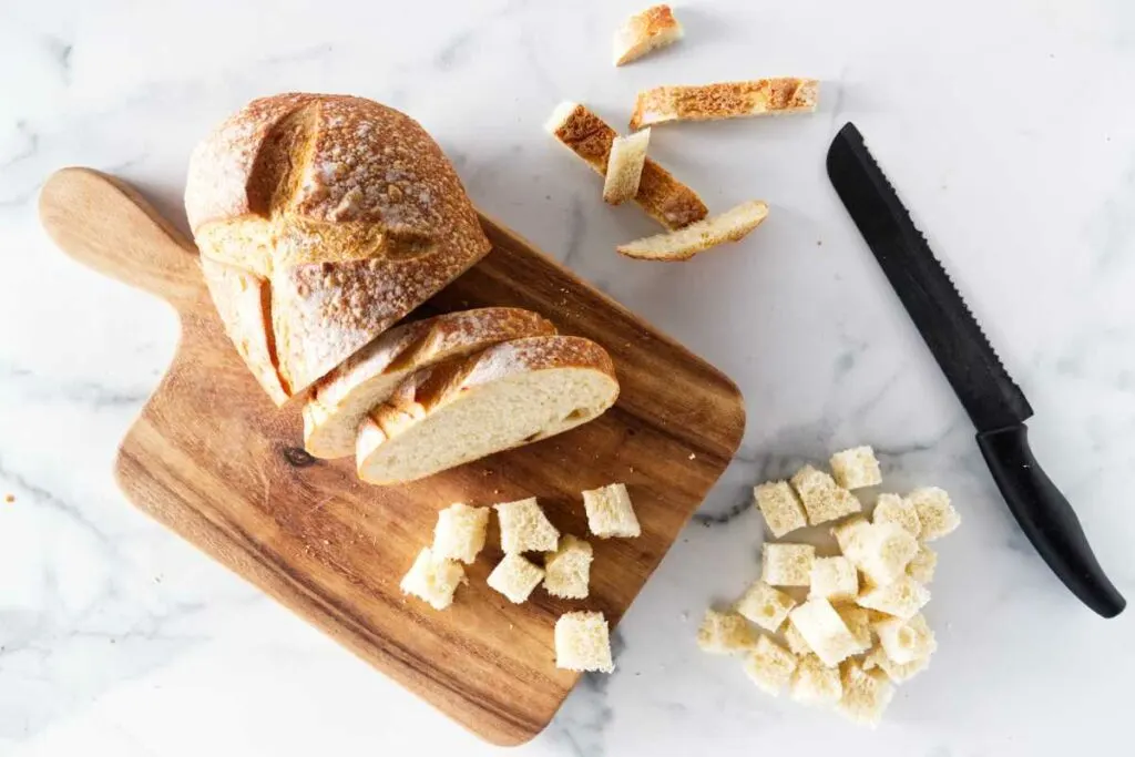 Slicing a loaf of bread to make croutons.