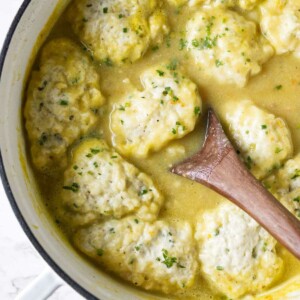 Drop dumplings on top of a pot of soup.