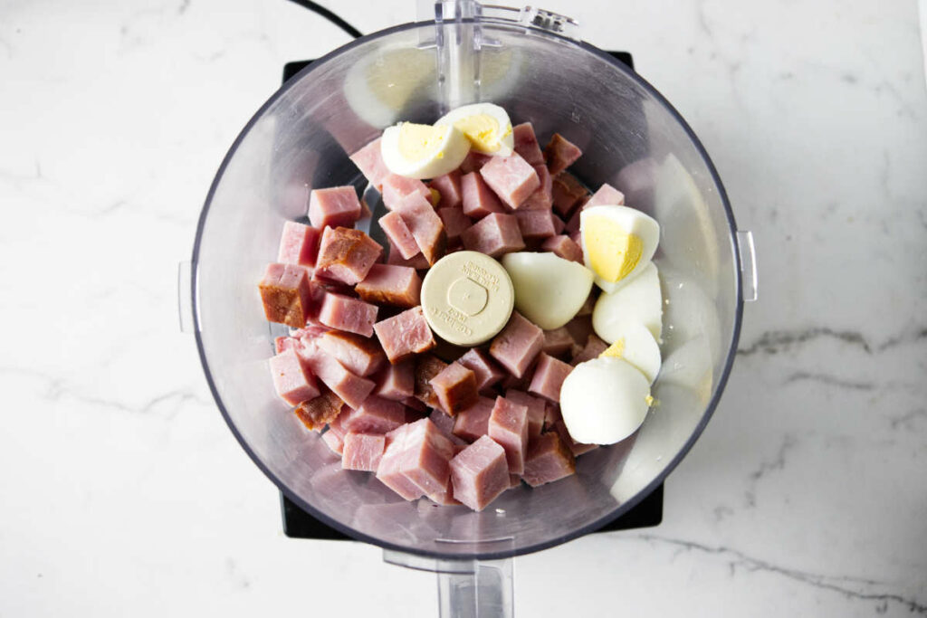 Ham and hard-boiled eggs in a food processor.
