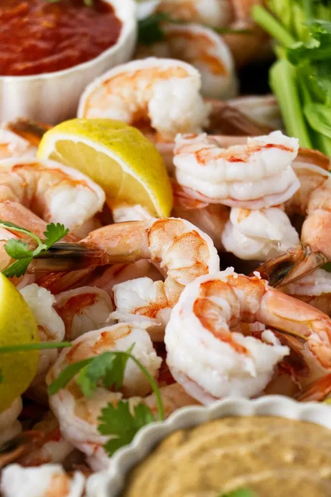 Several boiled shrimp on a platter.