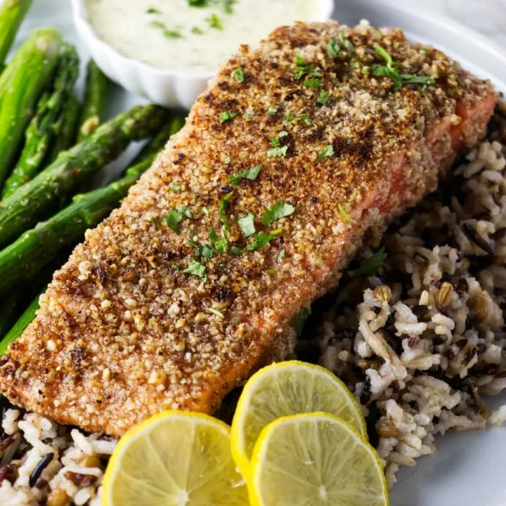 A pecan crusted trout fillet on a bed of rice.