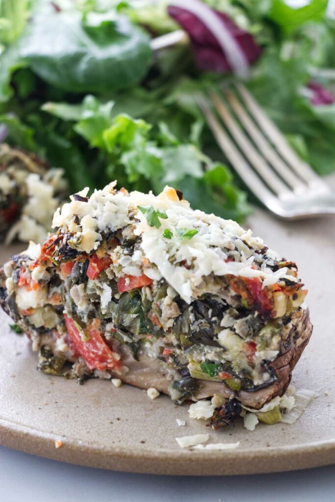 A stuffed mushroom sliced in half to show the stuffing.