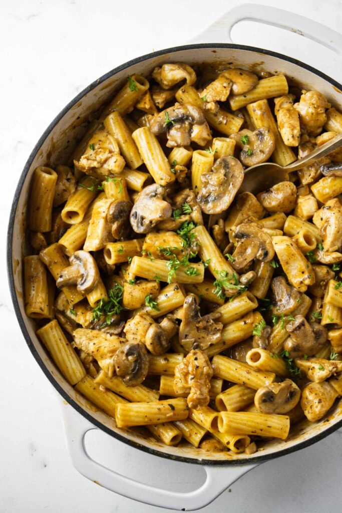 A skillet filled with chicken marsala pasta.