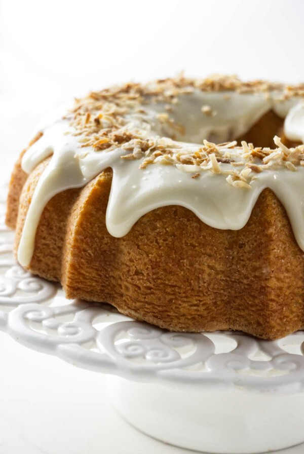 A coconut bundt cake on a cake platter.