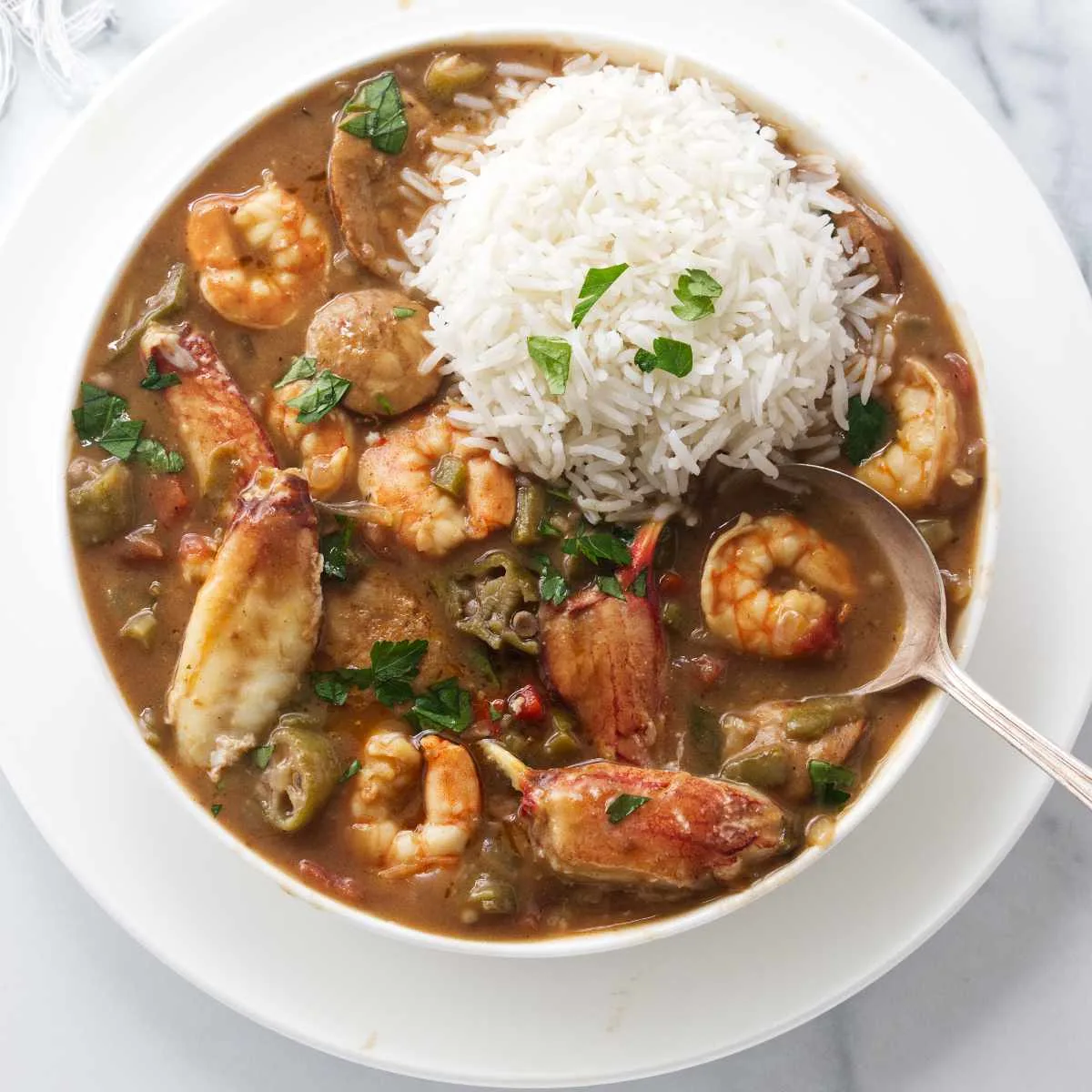 Seafood gumbo with a serving of white rice.