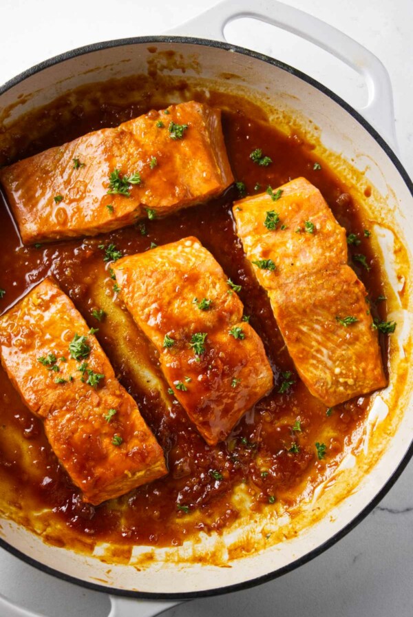 A skillet filled with marsala glazed salmon.