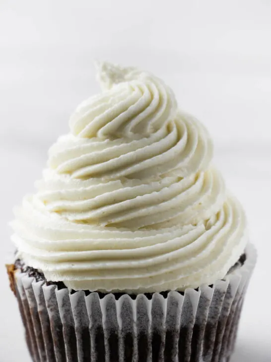 A swirl of coconut buttercream on a cupcake.