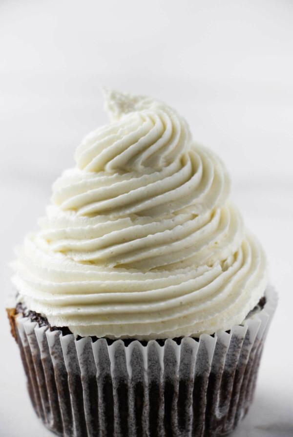 A swirl of coconut buttercream on a cupcake.