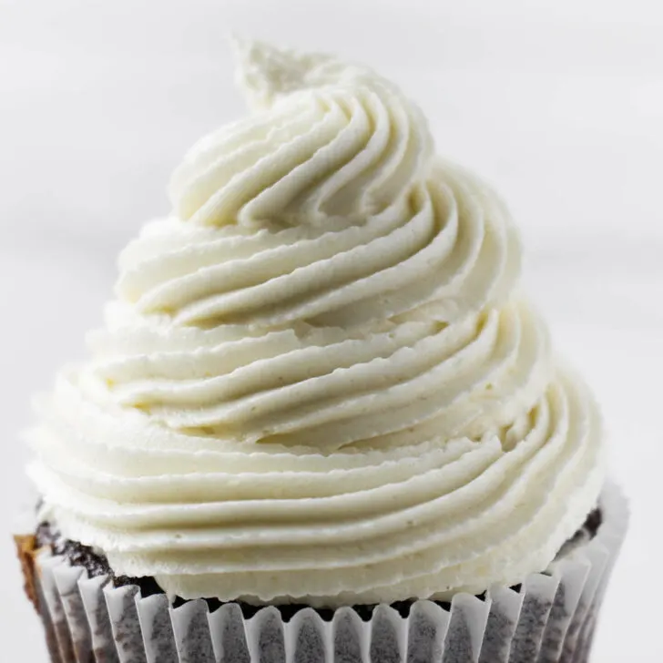 A swirl of coconut buttercream on a cupcake.