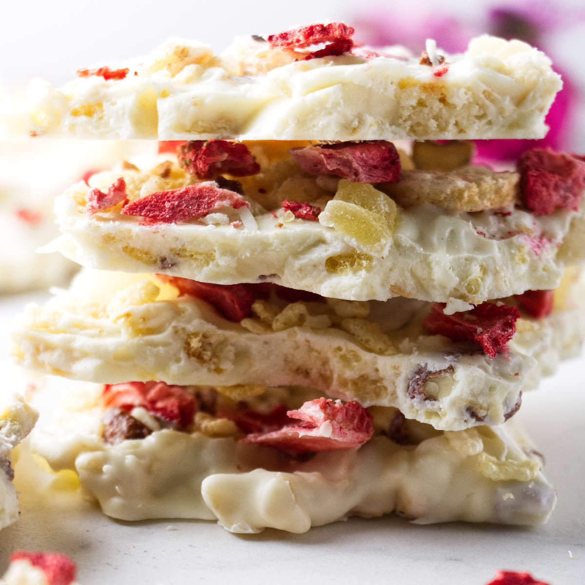 A stack of white chocolate bark with nuts and dried fruit.