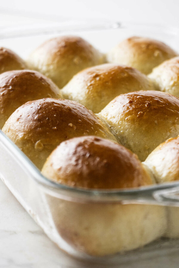 Hot oatmeal dinner rolls in a 13x9 inch baking dish.