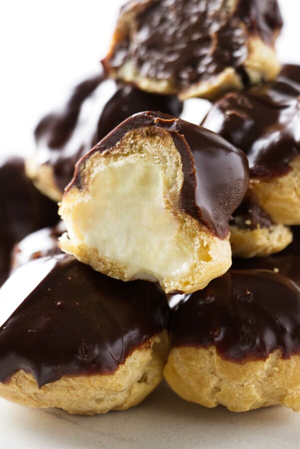 A stack of profiteroles filled with pastry cream.