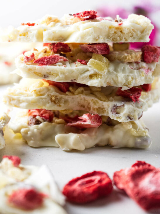 A stack of white chocolate bark loaded with fruit and nuts.