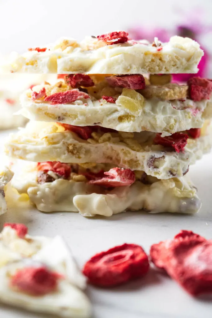 A stack of white chocolate bark loaded with fruit and nuts.