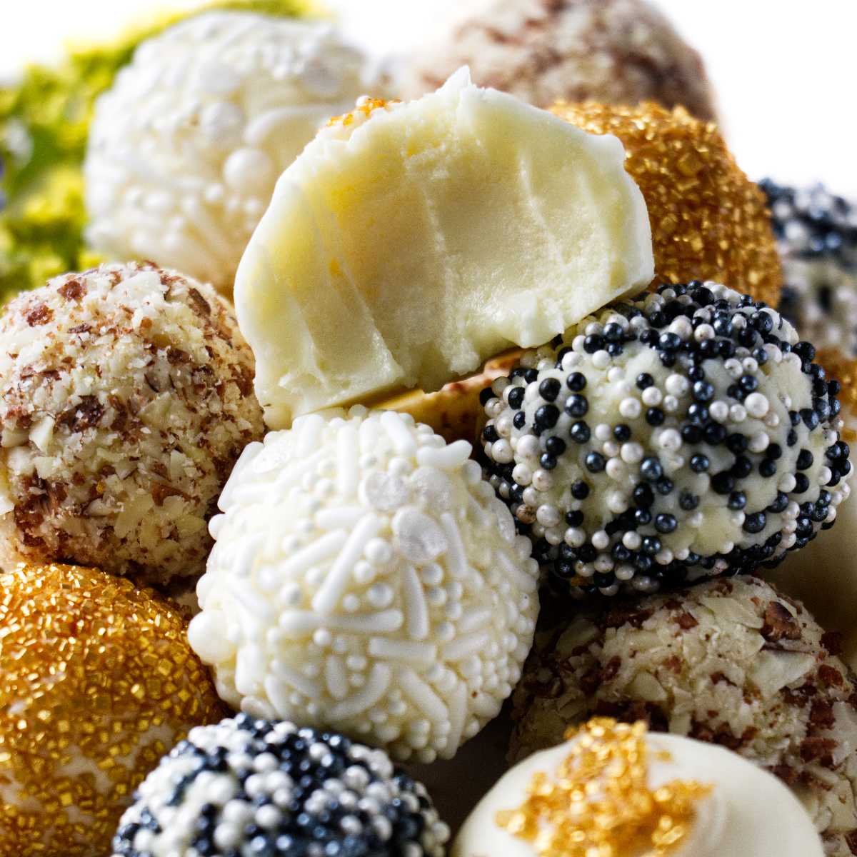 White chocolate truffles coated in chocolate and sprinkles.