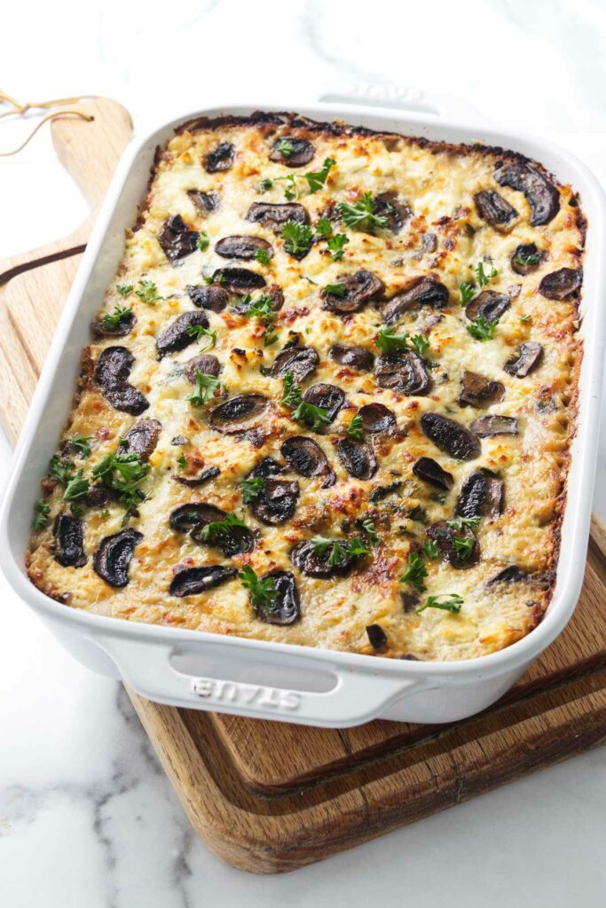 A 13 x 9 pan with a freshly baked cheesy mushroom lasagna.