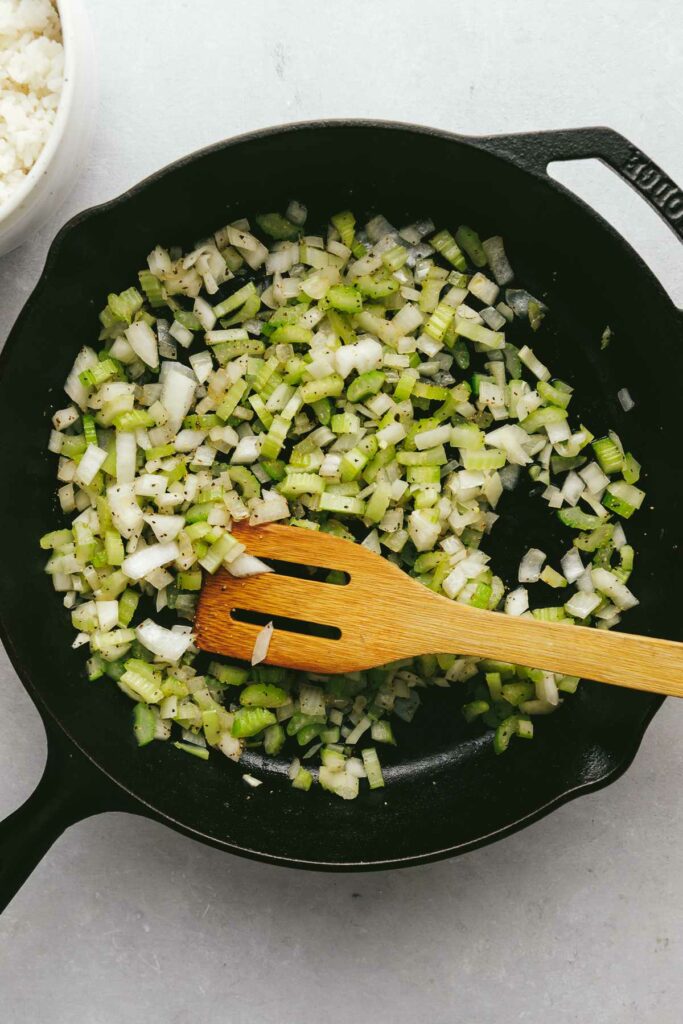 Cooking onion and celery in a skillet.