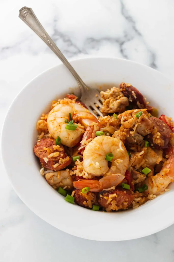 A creole seafood jambalaya in a bowl with a fork.