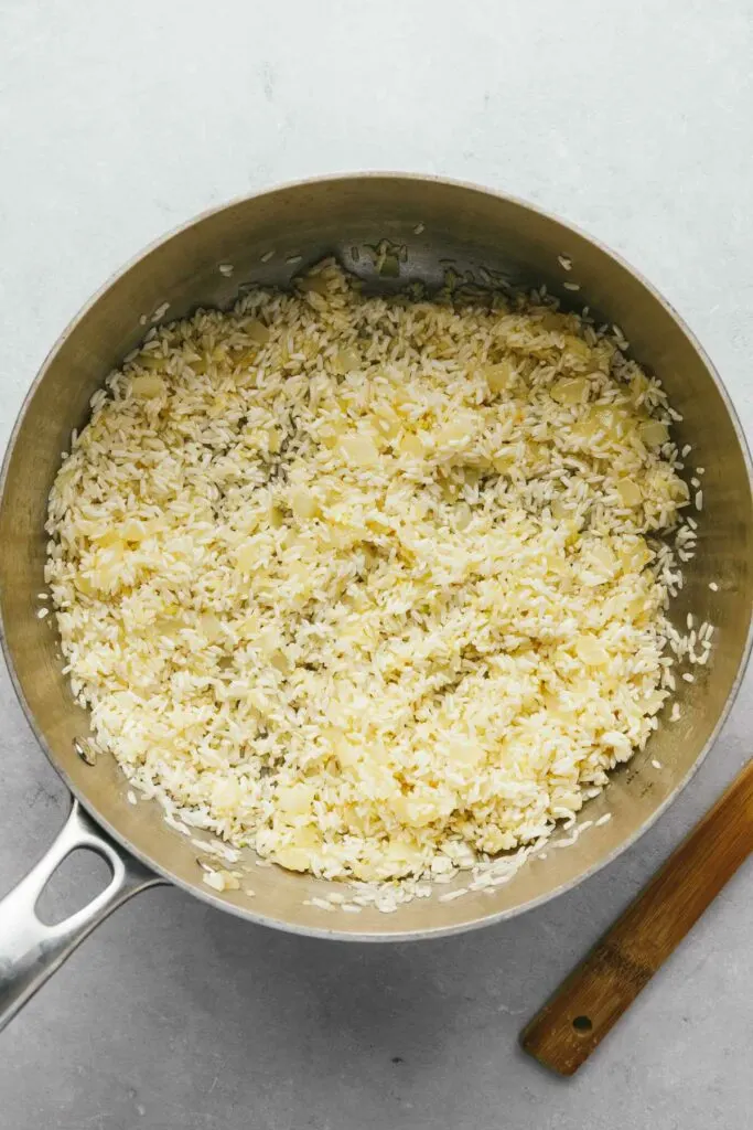 Cooking garlic butter rice in a saute pan.