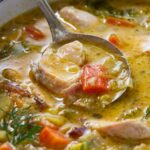 A spoon in a bowl of smoked trout chowder.