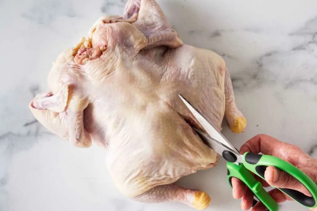 Scissors, cutting the chicken.