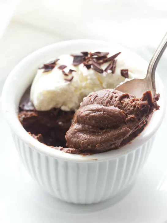 A serving of pots de creme with a spoonful being lifted from the dish.