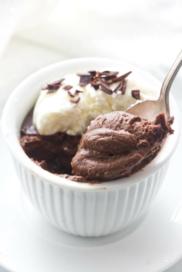 A serving of pots de creme with a spoonful being lifted from the dish.