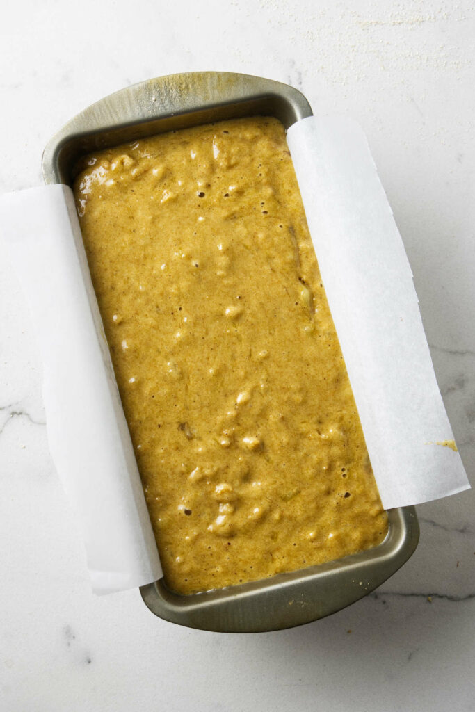 A bread pan with banana bread batter.