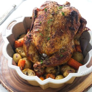 Bundt pan with a roasted chicken and vegetables.