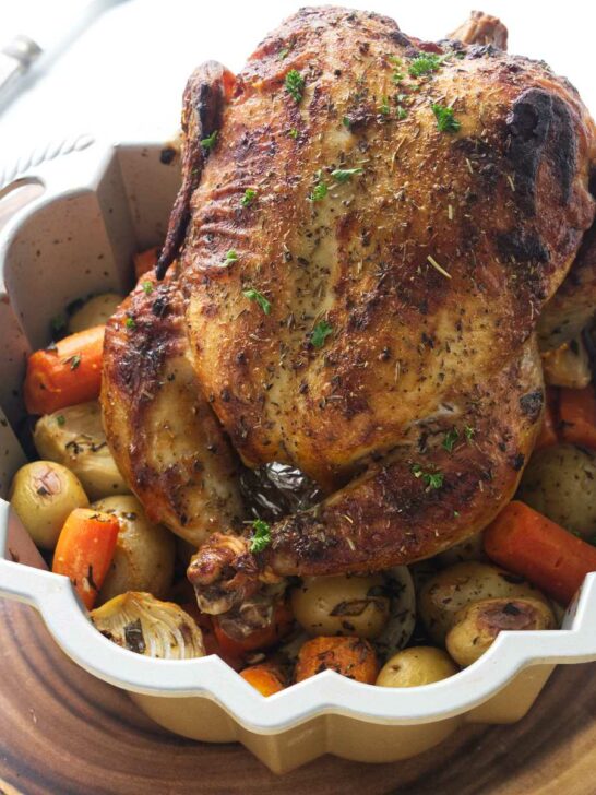 Bundt pan with a roasted chicken and vegetables.