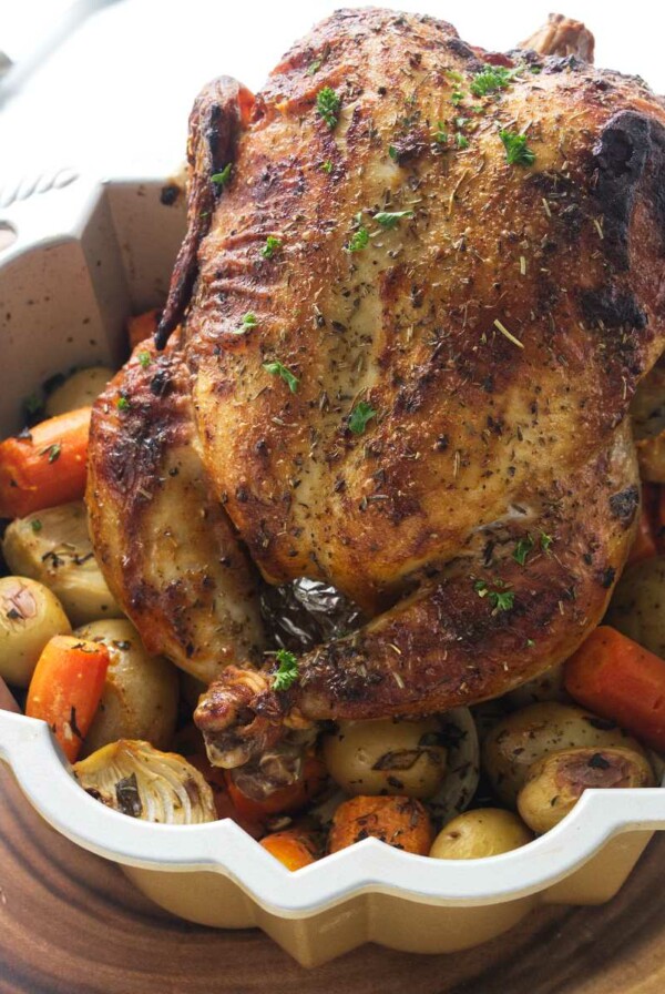 Bundt pan with a roasted chicken and vegetables.