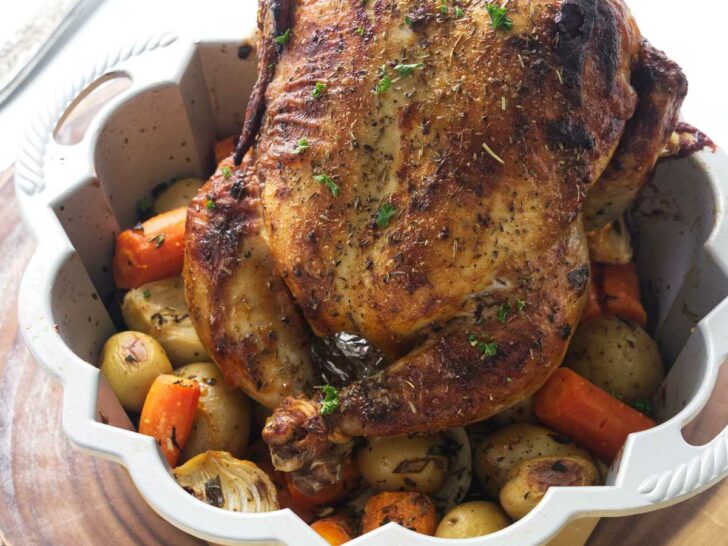 Bundt pan with a roasted chicken and vegetables.