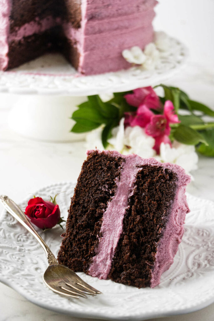 A slice of red wine chocolate cake on a plate.