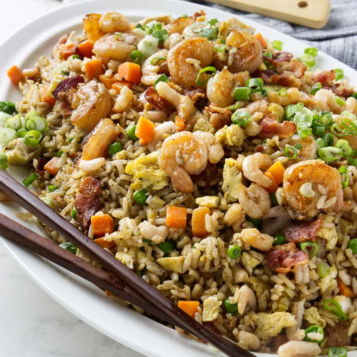 Shrimp fried rice on a white plate.