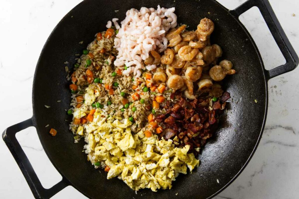 Fried rice with shrimp, bacon, eggs, and veggies.