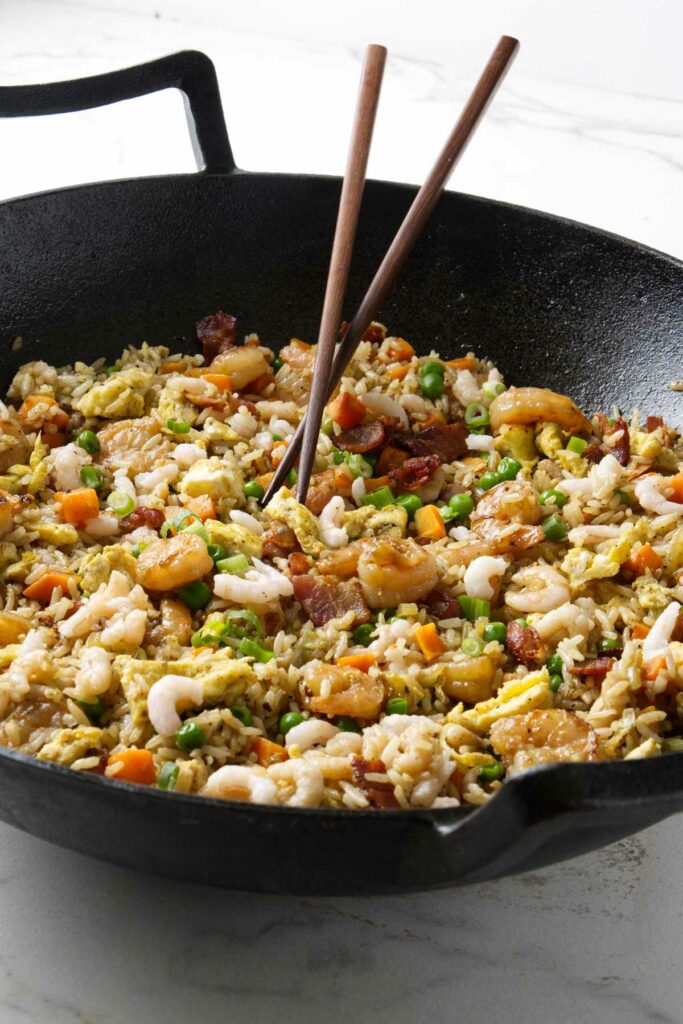 A wok filled with shrimp fried rice.