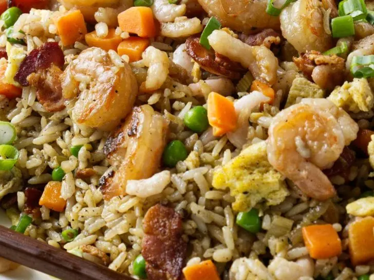 Shrimp fried rice on a platter with chopsticks.