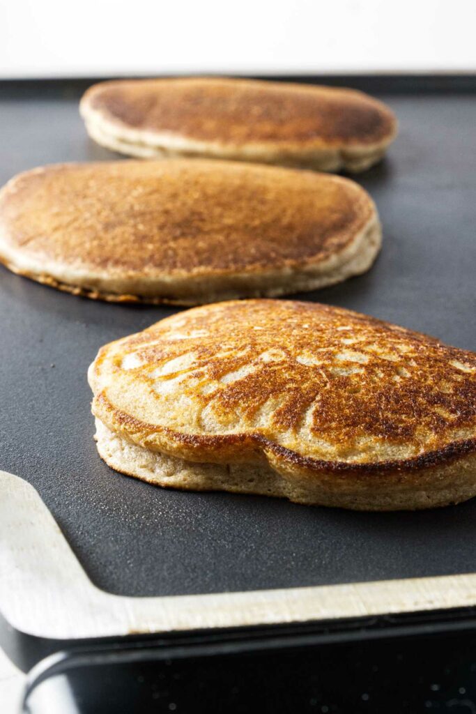 Sprouted spelt pancakes on a griddle.
