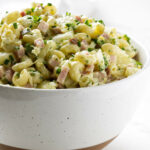 A bowl filled with Hawaiian potato salad with macaroni.