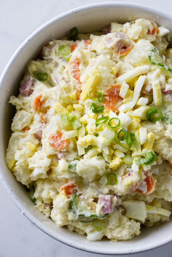 A serving bowl filled with Japanese potato salad.