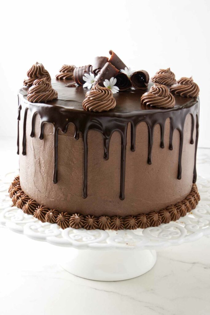 A 9-inch chocolate cake with a chocolate ganache drip.