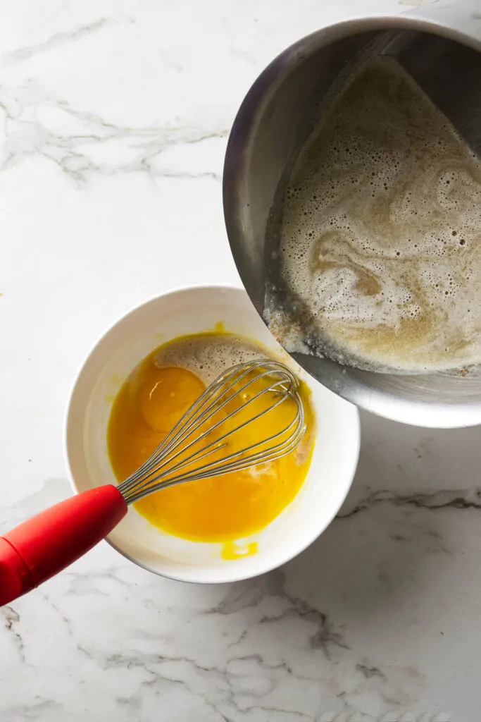 Tempering egg yolks for butter ice cream.