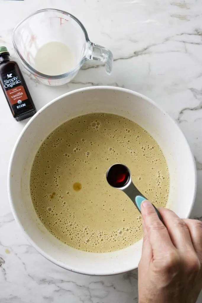 Adding cream and vanilla extract to butter ice cream mixture.