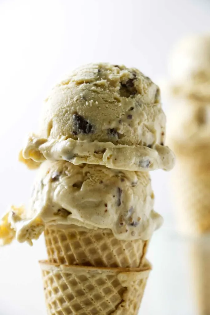 Two scoops of browned butter ice cream with chocolate toffee bits.