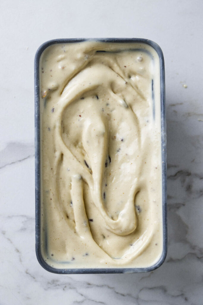 Brown butter ice cream spread in a bread pan and ready for the freezer.