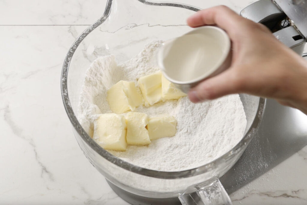 Mixing butter and coconut oil with the dry ingredients.