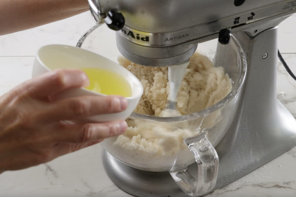 Adding egg whites to the cake batter.