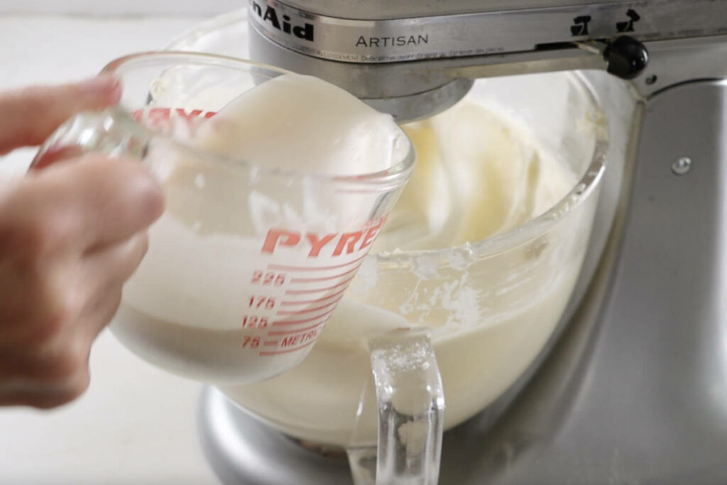 Adding coconut milk to the batter.