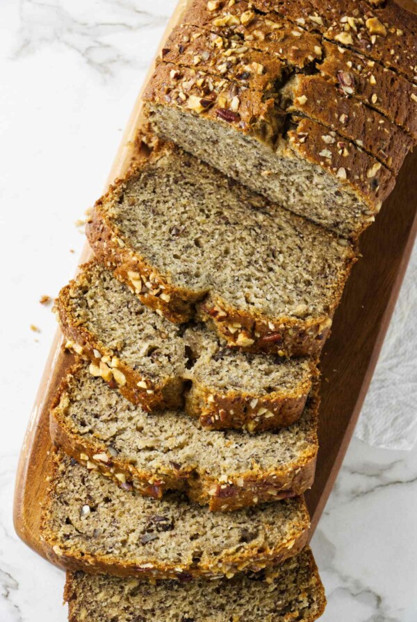 Several slices of copycat starbucks banana bread on a cutting board.