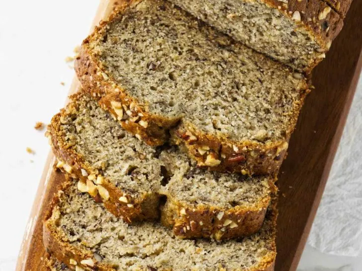 Several slices of copycat starbucks banana bread on a cutting board.